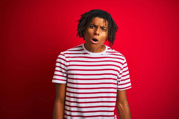 Young Afro Man Dreadlocks Wearing Striped Shirt Standing Isolated Red — Stock Photo, Image