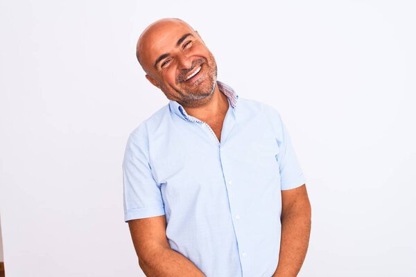 Middle age handsome man wearing casual shirt standing over isolated white background looking away to side with smile on face, natural expression. Laughing confident.