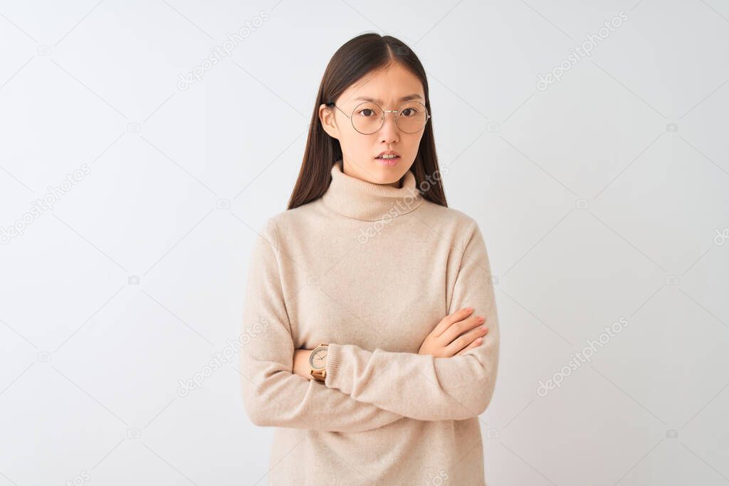 Young chinese woman wearing turtleneck sweater and glasses over isolated white background skeptic and nervous, disapproving expression on face with crossed arms. Negative person.