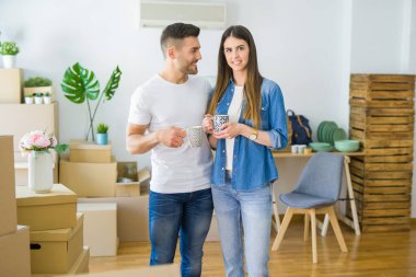 Güzel çift yeni bir eve hareket, neşeli içmek gülümseyen