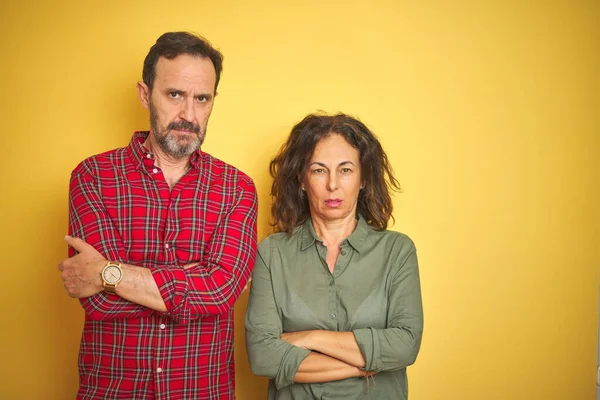 Beautiful Middle Age Couple Isolated Yellow Background Skeptic Nervous Disapproving — Stockfoto