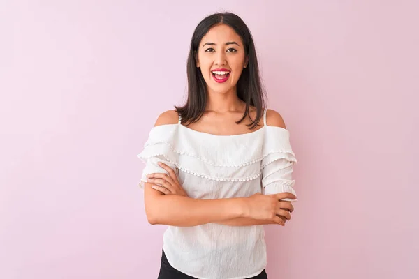 stock image Beautiful chinese woman wearing white t-shirt standing over isolated pink background happy face smiling with crossed arms looking at the camera. Positive person.
