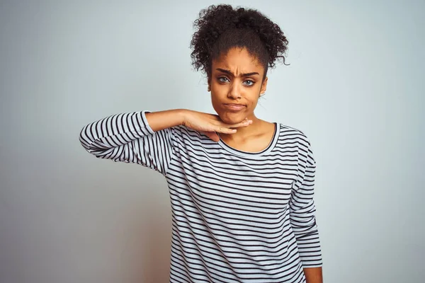 African american woman wearing navy striped t-shirt standing over isolated white background cutting throat with hand as knife, threaten aggression with furious violence