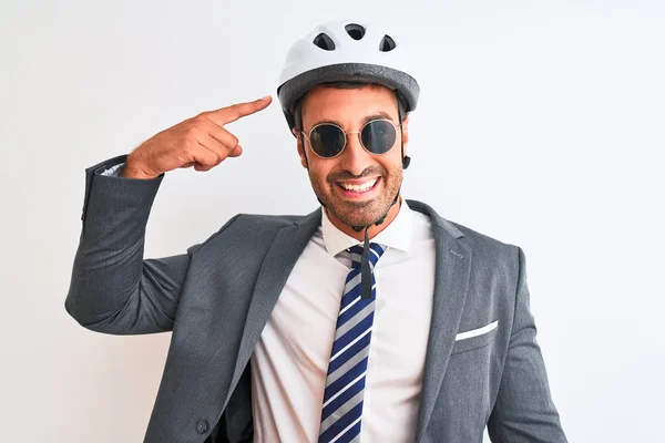 Young handsome business man wearing bike helmet and sunglasses over isolated background very happy pointing with hand and finger