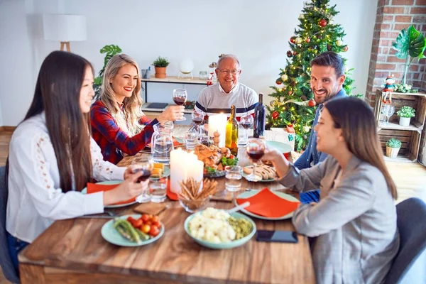 Beautiful family meeting smiling happy and confident. Eating roasted turkey celebrating Christmas at home