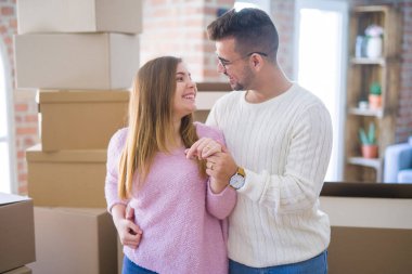 Gülümseyen neşeli genç çift alyansını gösteriyor, ünlü.