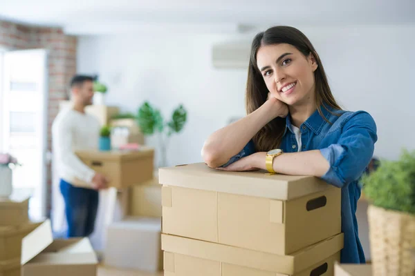 stock image Young couple moving to a new home, beautiful woman smiling leani