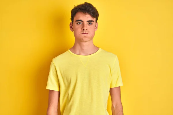 Teenager Boy Wearing Yellow Shirt Isolated Background Puffing Cheeks Funny — ストック写真