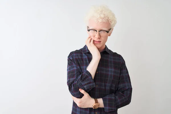 Young albino blond man wearing casual shirt and glasses over isolated white background thinking looking tired and bored with depression problems with crossed arms.