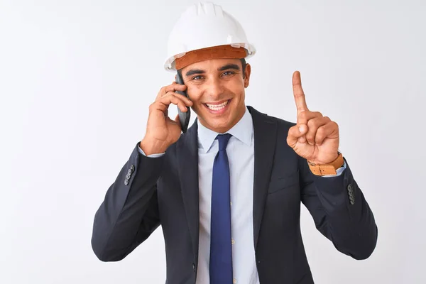 Young Architect Man Wearing Helmet Talking Smartphone Isolated White Background — Stock Photo, Image