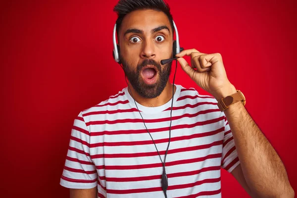 Young Indian Call Center Agent Man Using Headset Isolated Red — ストック写真