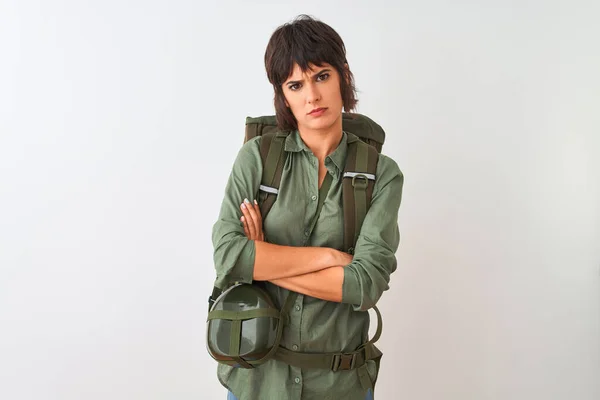 Beautiful hiker woman wearing backpack and water canteen over isolated white background skeptic and nervous, disapproving expression on face with crossed arms. Negative person.