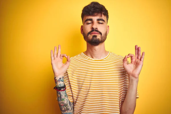 Young Man Tattoo Wearing Striped Shirt Standing Isolated Yellow Background — ストック写真