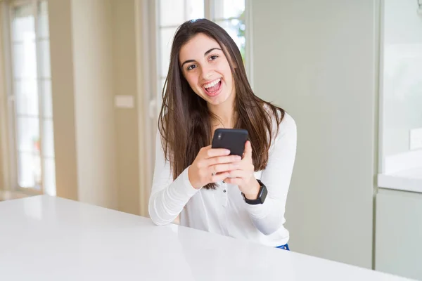 Νεαρή Γυναίκα Που Χρησιμοποιεί Smartphone Χαμογελαστά Χαρούμενα Μηνύματα Και Δακτυλογράφηση — Φωτογραφία Αρχείου