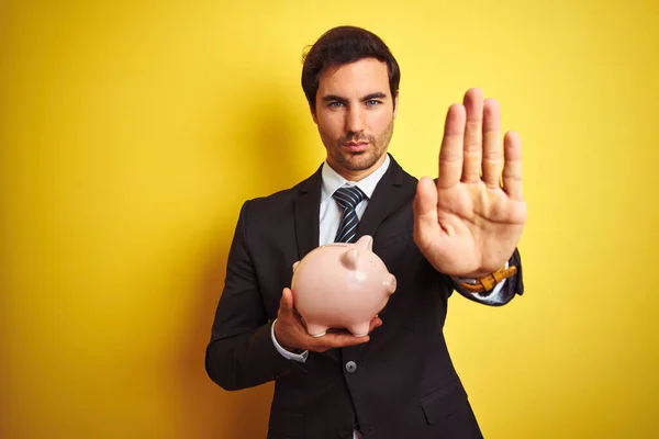 Young Handsome Businessman Holding Piggy Bank Isolated Yellow Background Open — Stock Photo, Image