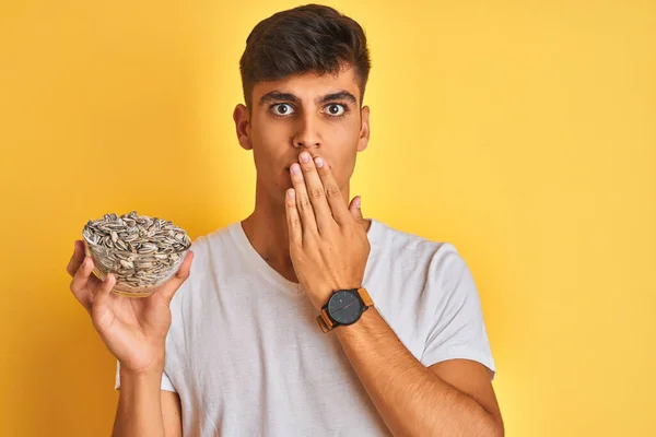 Young Indian Man Holding Bowl Sunflowers Seeds Isolated Yellow Background — Stock Photo, Image