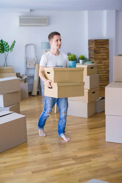 happy man with boxes moving to new house