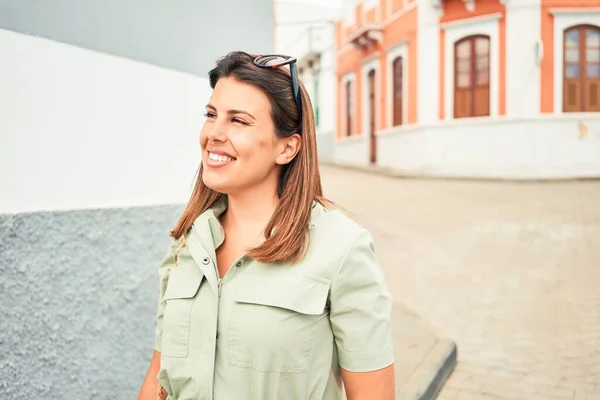 Young beautiful woman on romatic village walking on the town street on a sunny day