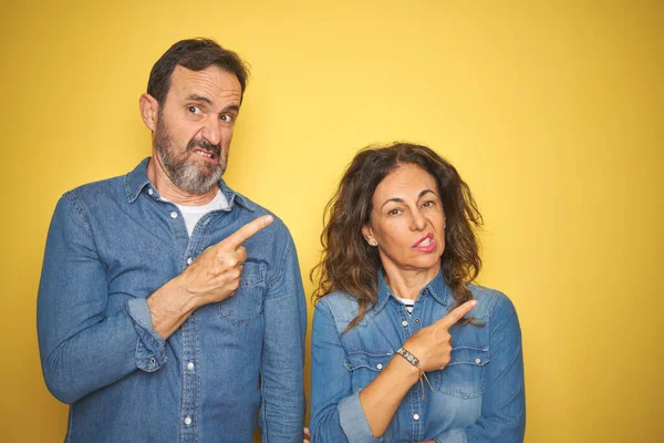 Belo Casal Meia Idade Juntos Sobre Fundo Amarelo Isolado Apontando — Fotografia de Stock