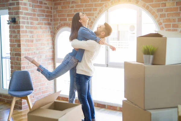 Beautiful couple jumping and hugging in love, smiling very happy — Stock Photo, Image