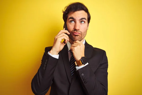 Young Handsome Businessman Talking Smartphone Isolated Yellow Background Serious Face — Stock Photo, Image