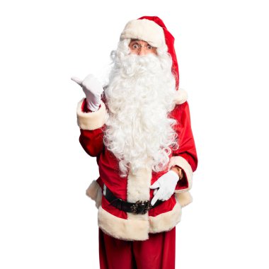Orta yaşlı, yakışıklı, Noel Baba kostümü ve sakallı bir adam. Şaşırmış, el parmağı yanda, ağzı açık, şaşkın bir ifade..