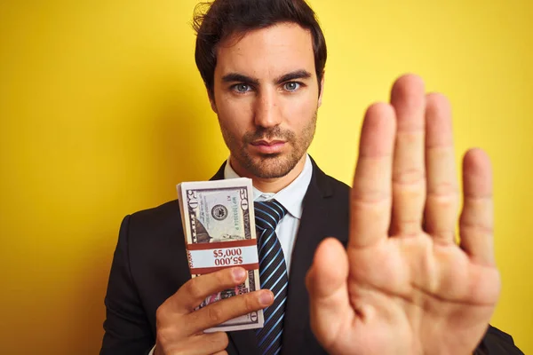 Young Handsome Businessman Wearing Suit Holding Dollars Isolated Yellow Background — Stock Photo, Image