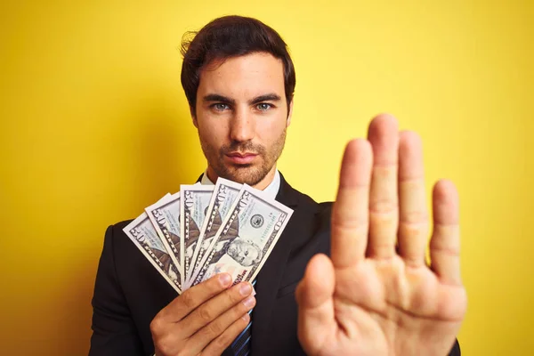 Young Handsome Businessman Wearing Suit Holding Dollars Isolated Yellow Background — Stock Photo, Image