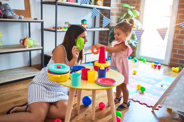 Young Beautiful Teacher Toddler Building Pyramid Using Hoops Table Kindergarten — Stock Photo, Image