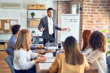 Group of business workers working together in a meeting. One of them making presentation to colleagues at the office