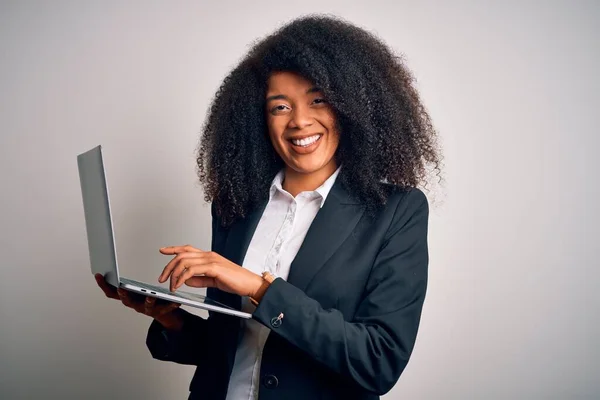 Young african american business woman with afro hair using computer laptop from job with a happy face standing and smiling with a confident smile showing teeth