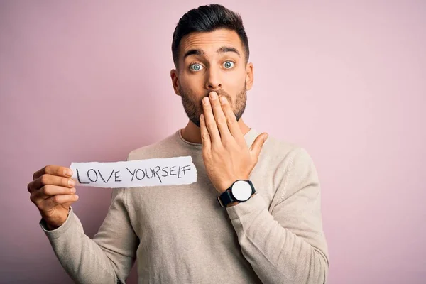 Young Handsome Man Holding Paper Self Love Message Pink Background — Stock Photo, Image