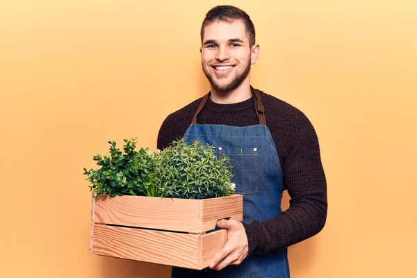 Young Handsome Man Wearing Gardener Apron Holding Pant Pot Looking — Stock Photo, Image
