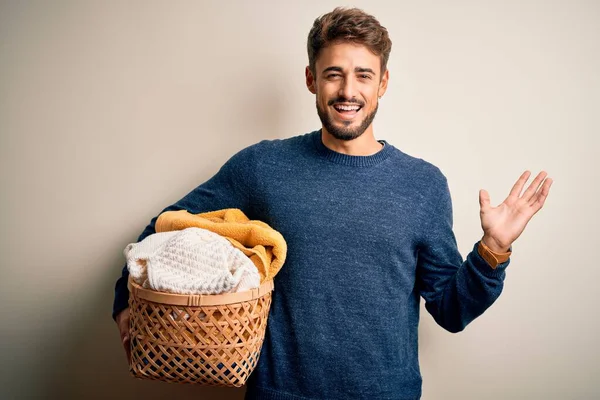 Young Man Doing Housework Holding Wicker Basket Clothes White Background — Stock Photo, Image