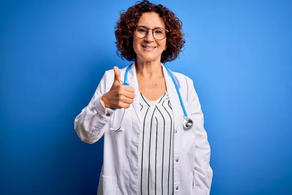 Kobieta Średnim Wieku Kręcone Włosy Lekarz Noszący Płaszcz Stetoskop Niebieskim — Zdjęcie stockowe