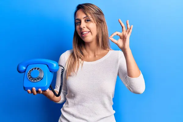 Young Beautiful Woman Holding Vintage Telephone Doing Sign Fingers Smiling — Stock Photo, Image