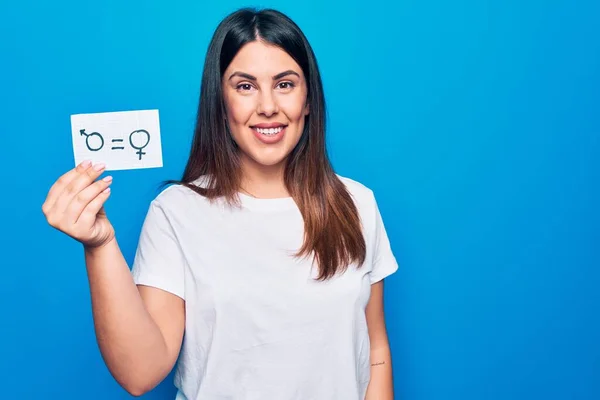 Beautiful woman asking for sex discrimination holding paper with gender equality concept looking positive and happy standing and smiling with a confident smile showing teeth