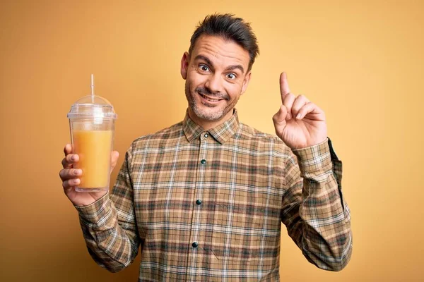 Young Handsome Man Drinking Healthy Orange Juice Using Straw Yellow — Stock Photo, Image