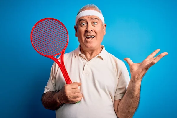 Middle Age Hoary Sportsman Playing Tennis Using Racket Isolated Blue — Stock Photo, Image