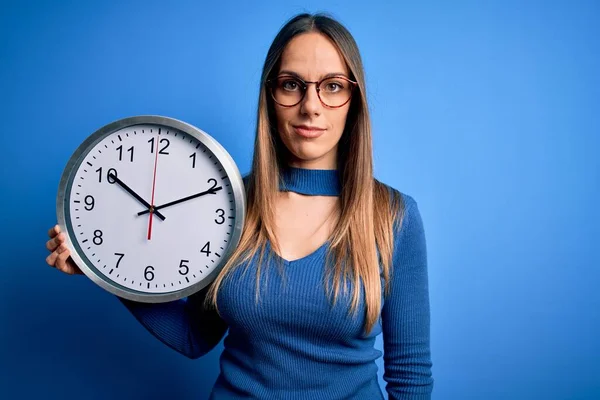 Young Blonde Woman Blue Eyes Holding Big Minute Clock Isolated — Stock Photo, Image