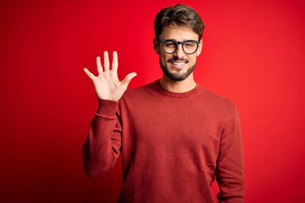 Young Handsome Man Beard Wearing Glasses Sweater Standing Red Background — Stock Photo, Image