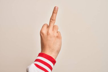 Hand of caucasian young man showing fingers over isolated white background showing provocative and rude gesture doing fuck you symbol with middle finger
