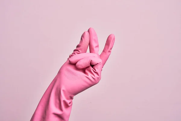 Ręka Białego Młodzieńca Rękawicą Czyszczącą Odizolowanym Różowym Tle Pstrykające Palce — Zdjęcie stockowe