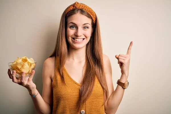 Young Beautiful Redhead Woman Holding Bowl Potato Chips Isolated White — Stock Photo, Image