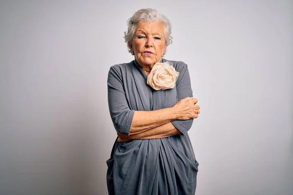 Senior beautiful grey-haired woman wearing casual dress standing over white background shaking and freezing for winter cold with sad and shock expression on face