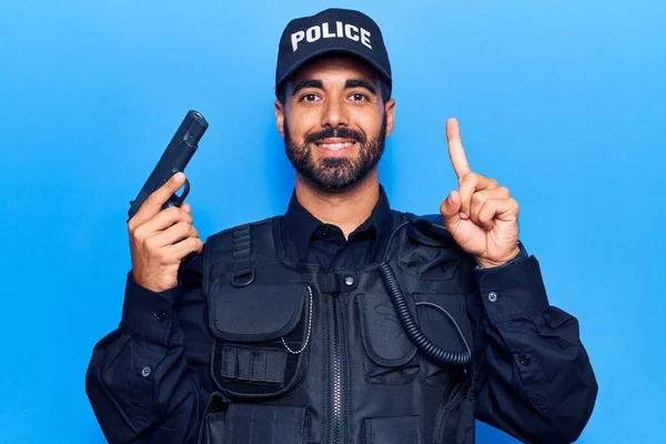 Jovem Hispânico Vestindo Uniforme Policial Segurando Arma Sorrindo Com Uma — Fotografia de Stock