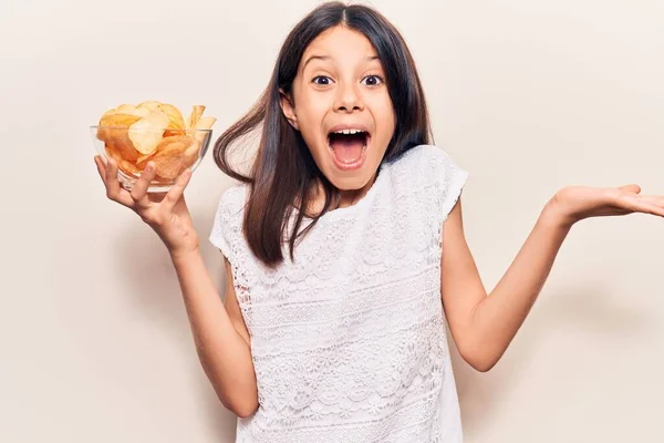 Beautiful Child Girl Holding Potato Chip Celebrating Victory Happy Smile — Stock Photo, Image