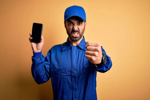 Mechanic Man Beard Wearing Blue Uniform Cap Holding Smartphone Showing — Stock Photo, Image