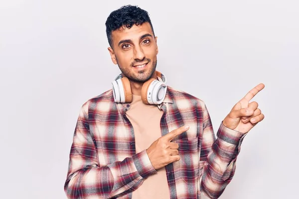 Jovem Hispânico Ouvindo Música Usando Fones Ouvido Sorrindo Olhando Para — Fotografia de Stock