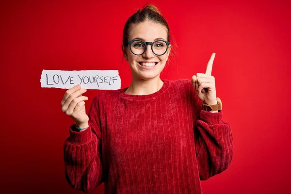 Young Beautiful Redhead Woman Holding Paper Love Yourself Message Surprised — Stock Photo, Image